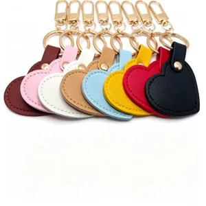 Colorful heart-shaped leather keychain detail showing exquisite gold metal hardware and stitching.