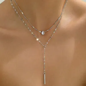 Detailed view of a silver double-layered Y-shaped necklace with waterdrop crystal.