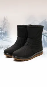 Detail view of black waterproof snow boots with side zipper and quilted pattern for winter.