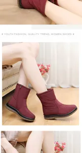 Detail view of stylish wine red winter snow boots with side zipper and warm lining