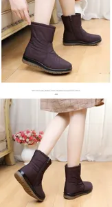 Detailed view of women's warm brown waterproof snow boots with side zipper closure
