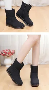 Side view detail of black waterproof snow boots for women with zipper and thick anti-slip sole