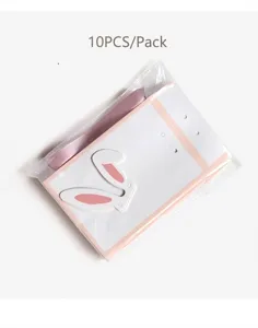 Set mit 10 Geschenktüten mit Hasenohren und rosa Schleifen in Klarsichtverpackung.