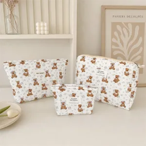 Lot de trois trousses à maquillage matelassées avec motif ours en plusieurs tailles.