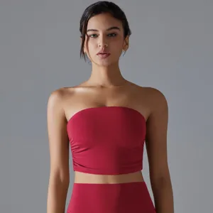 A front view detail of a red strapless yoga tube top with pleated side details for fitness