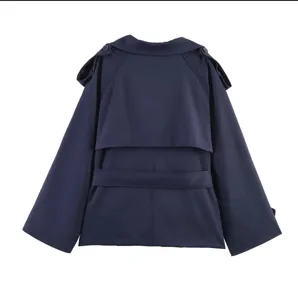 Back view of a navy blue cropped trench coat with storm flap and shoulder epaulettes