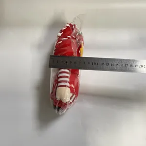 Gnomo de peluche navideño Rudolph medido con una regla metálica que muestra el ancho
