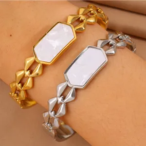 Close-up of geometric stainless steel bracelets with white mother-of-pearl inlay