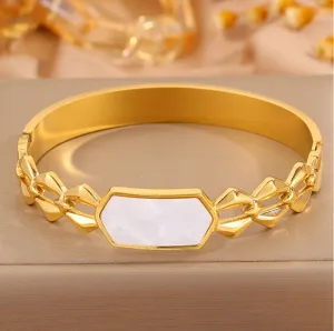 Elegant close-up view of golden stainless steel bangle with white mother of pearl inlay