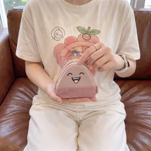 Close-up of cute cartoon rice ball coin purse in pink corduroy