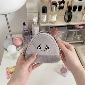 Detailed view of cute Japanese-style cartoon rice ball corduroy coin purse held in hands