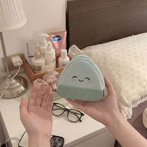 Detailed view of mint green cartoon rice ball coin purse held in hands