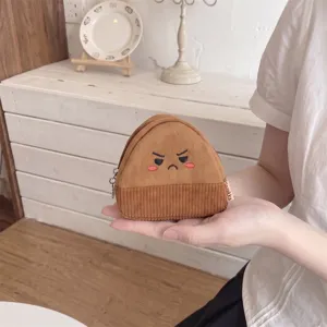 Handheld view of a cute brown corduroy rice ball coin purse with an angry face expression