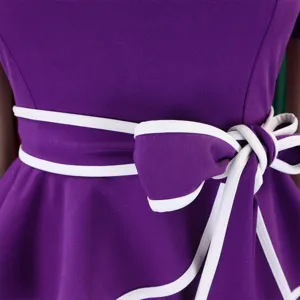 Detailed macro view of a purple ruffle dress featuring a white-trimmed sash bow tie