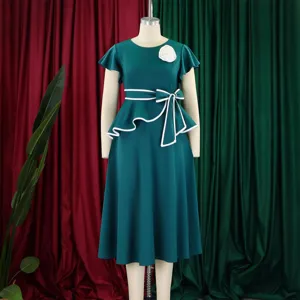 Front detail of elegant green midi dress featuring ruffled sleeves and waist bow