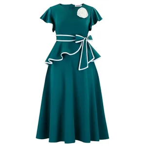 Elegant dark green peplum midi dress featuring white ruffle trim and a flower brooch detail