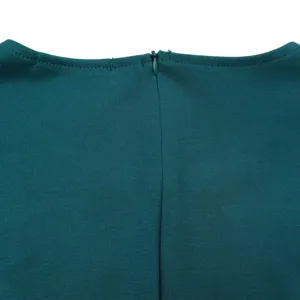 Detailed macro view showing back neckline and invisible zipper of a teal summer dress.