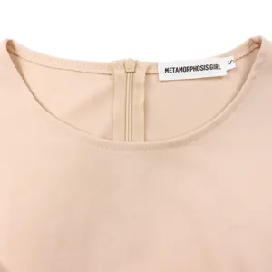 Close-up detail of beige dress back neckline featuring a zipper and brand woven label