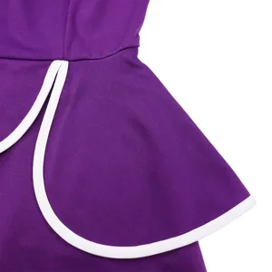 Detailed view of a purple dress featuring a peplum design with crisp white piping