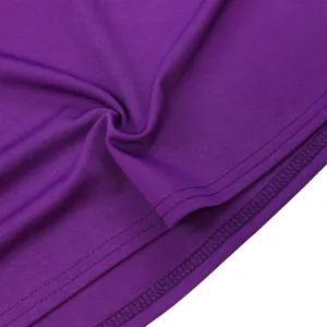 Close-up of purple dress hem showing neat double stitching lines and soft fabric texture.