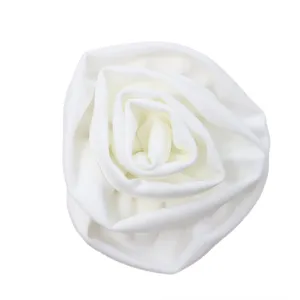 Detailed view of the elegant white fabric rose flower embellishment on women dress.