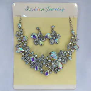 Dettaglio del set di collana e orecchini con farfalla e fiori in strass cangianti