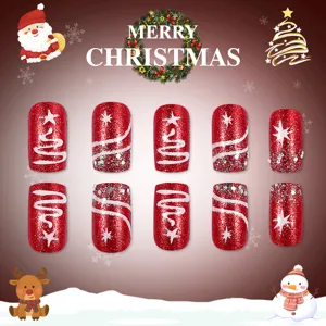 Detail view of red glitter Christmas press-on nails with white tree patterns.