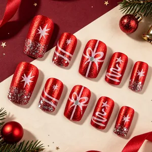 Detailed view of Christmas press-on nails with shiny red glitter and snowflake designs