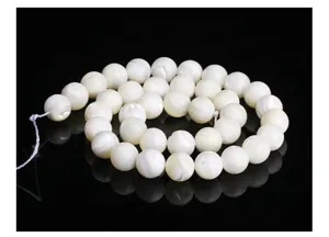 Macro view of natural white mother of pearl round loose beads for DIY jewelry making