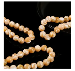 Close-up detail of natural round trochus shell loose beads for DIY jewelry making