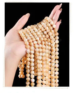 Close-up of natural Trochus shell round beads with pearlescent luster for DIY jewelry
