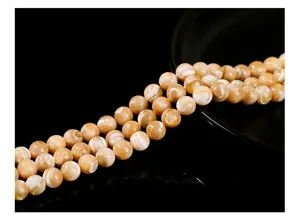 Detailed close-up of natural lustrous brown Trochus shell round beads for DIY jewelry