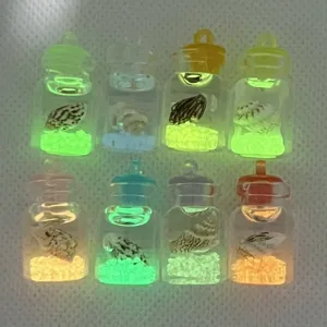 Miniature luminous drifting bottle pendants with conch shells and glowing stones for DIY crafts.