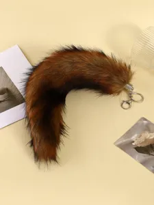 Fluffy faux fox fur tail keychain and bag charm, perfect for cosplay, cute plush accessory.