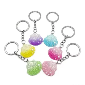 Set of 6 colorful resin seashell keychains with sparkling glitter and cute pearl details.