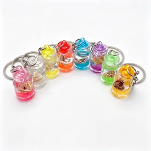 Close up of colorful mini drift bottle keychains with tiny shells inside, transparent glass design.