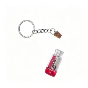 Miniature glass drift bottle keychain accessory detail showing tiny vial with red liquid.
