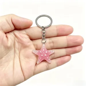 Sparkling pink resin starfish keychain, cute glitter star pendant bag charm and key ring gift.