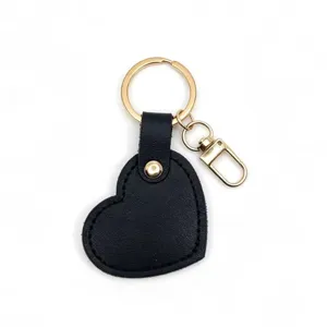Black heart leather keychain detail shot, minimalist DIY bag pendant and key ring accessory.