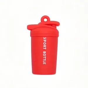 Mini shaker bottle keychain detail view, red fitness gym pendant close-up accessory charm.