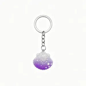 Detailed view of the cute purple glitter seashell keychain, perfect ocean beach style bag accessory.