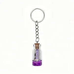 Detailed view of ocean theme wishing bottle keychain with purple sand and cute miniature charm.
