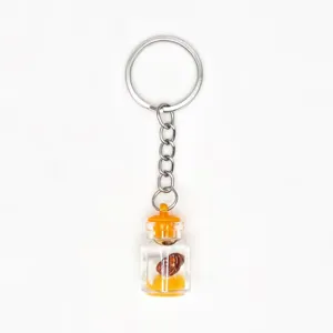 Detailed view of a creative glass drifting bottle keychain with metal ring and pendant.