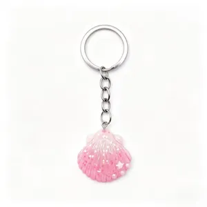 Close-up detail of the cute pink glitter seashell keychain pendant with metal ring and chain.