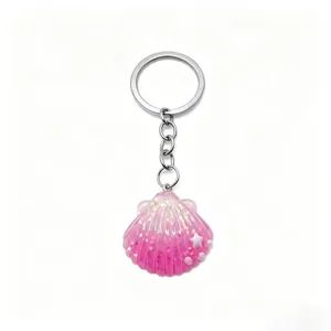 Pink glitter seashell keychain detail showing the sparkling resin charm and metal ring.