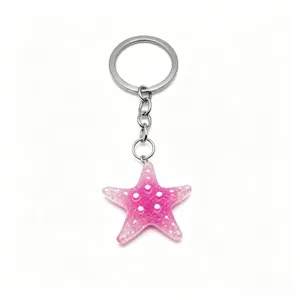 Pink glitter starfish keychain, cute resin five-pointed star bag pendant gift accessory.