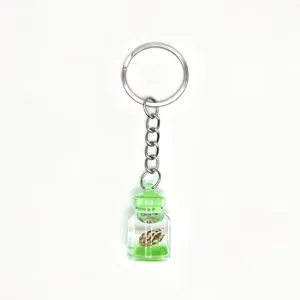 Creative glowing drift bottle keychain with mini conch and green liquid, stylish bag charm.