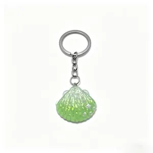 Green glitter seashell keyring detail, resin shell pendant charm, metal key ring for bag accessory.