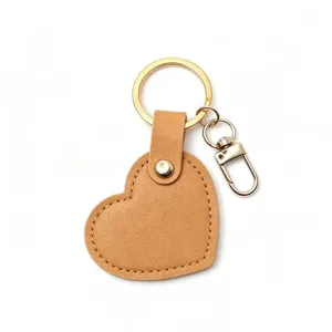 Detail view of the heart leather keychain close up showing metal hardware and fine stitching.