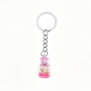 Ocean style drifting bottle keychain with miniature conch and pink sand for cute DIY bag charms.